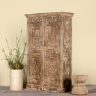 Side angle image of a hand-carved reclaimed wood wardrobe with vintage finish – a sustainable furniture piece ideal for Indian home decor and rustic interiors.
