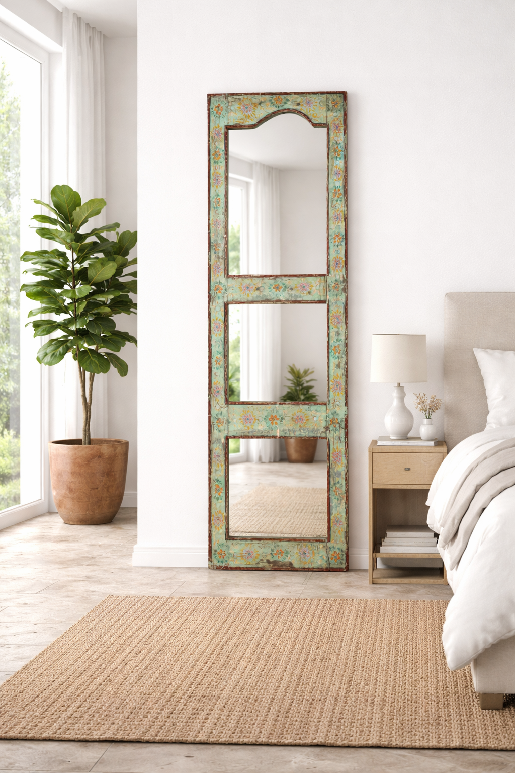 Lifestyle imagination of a painted wooden mirror Keshod made from recycled teak wood with hand-painted detailing. A sustainable furniture piece perfect for boho chic living room decor.