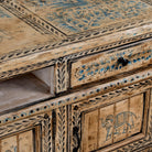 Close up image of a hand painted TV unit in reclaimed wood with Indian elephant and horse motifs, drawers and cabinets, 180 × 45 × 60 cm.