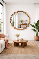 Lifestyle imagination of a wavy round mango wood mirror Khavda with scalloped frame design. A bold wall decoration and artisan-crafted statement piece for bohemian, rustic, or modern interiors.
