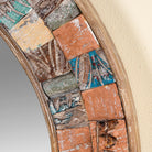 Close up image of a handcrafted round mango wood mirror with patchwork reclaimed frame and distressed finish; ideal for vintage home decor, 80 × 4 cm.