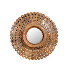 White background image of a round mango wood mirror Kiaan with concentric carved design and mirror inlays. A piece of unique wall decor combining artisanal craftsmanship and rustic bohemian charm.