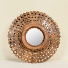 Image of round mango wood mirror Kiaan with concentric carved design and mirror inlays. A piece of unique wall decor combining artisanal craftsmanship and rustic bohemian charm.