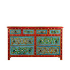White background image of a Kianraj hand painted reclaimed wood chest of drawers with red frame, blue floral fronts and eight drawers 150cm