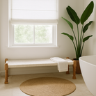 Lifestyle imagination of a low mango wood bench with handwoven cotton seat and hand-carved recycled wood frame; 180 × 45 × 20 cm.