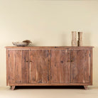 Front view of a sideboard with modern appeal made of acacia wood with brass fitted doorknobs and 4 doors.