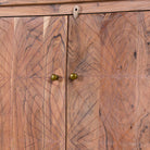 Close up picture of a sideboard with modern appeal made of acacia wood with brass fitted doorknobs and 4 doors.