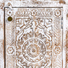Close up image of a set of two hand carved bedside tables with mandala and floral motifs; reclaimed wood in white washed furniture style, 50 × 40 × 72 cm.
