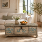 Lifestyle image of a hand-painted reclaimed teak wood chest with iron accents – teak wood chest and reclaimed wood furniture with bohemian artistic detail.