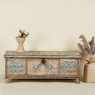 Large hand-painted chest made from old reclaimed wood, featuring intricate blue designs of elephants and floral motifs on a distressed beige background, with a central latch and a rustic vintage finish.
