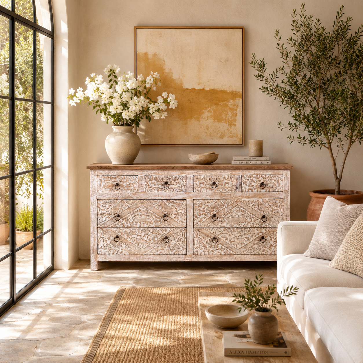 Lifestyle image of a hand-carved mango wood sideboard with elephant motifs and whitewashed finish; ideal for vintage home decor, 153 × 80 × 40 cm.