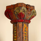 Close up image of an antique pair of carved wooden house pillars with original stone bases, weathered multicolour finish, 210 cm high, vintage home decor and boho chic living room accents.