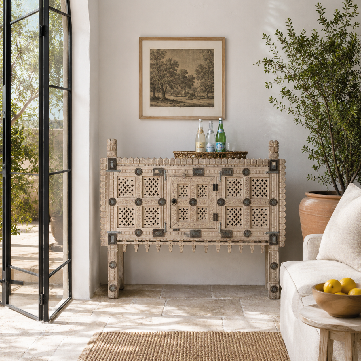 Lifestyle image of an sandblasted antique Indian teak chest with hand-carved details, original iron fittings, and a naturally aged finish, ideal for bohemian or vintage-inspired interiors.