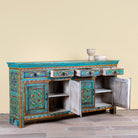 Side angle image with open doors of a Laksh hand painted reclaimed wood sideboard in boho style with distressed vintage finish and traditional Indian floral artwork.