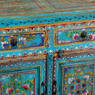 Close up image of a Laksh hand painted reclaimed wood sideboard in boho style with distressed vintage finish and traditional Indian floral artwork.