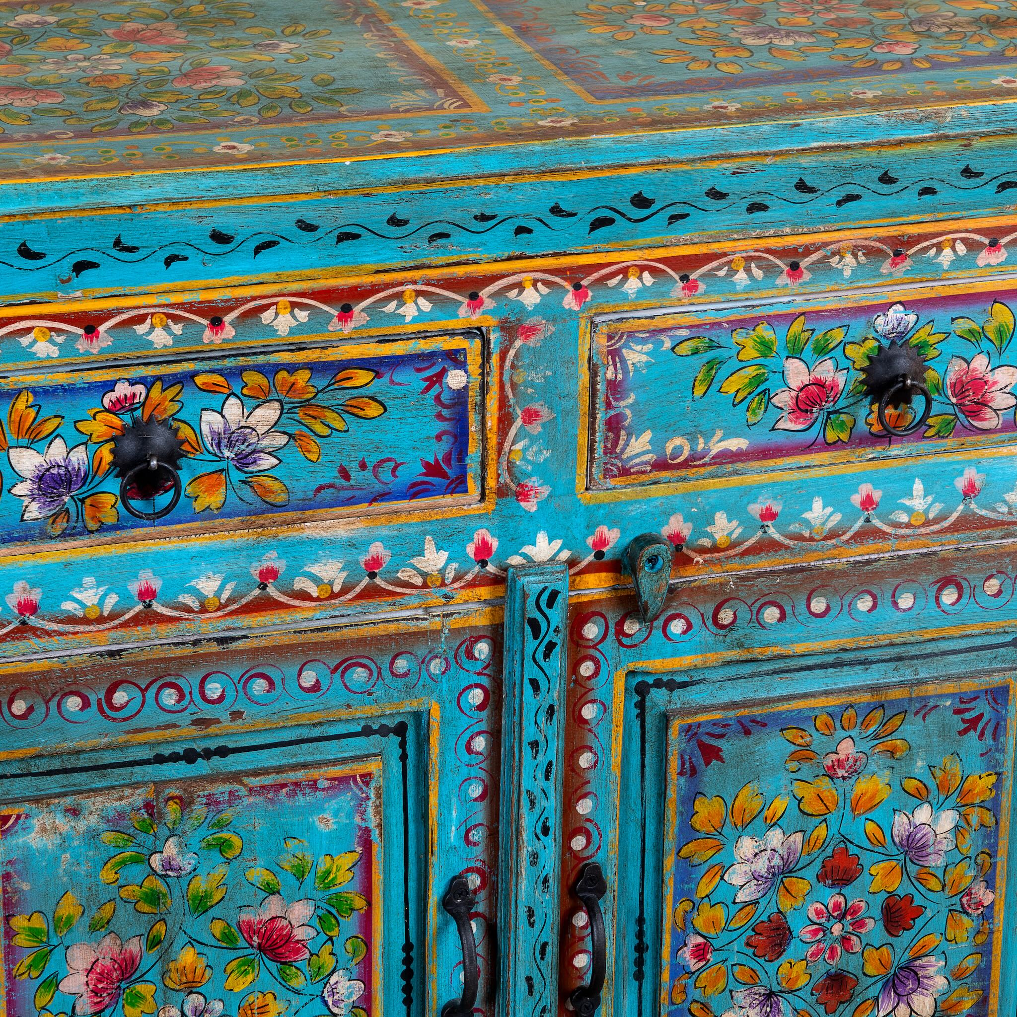 Close up image of a Laksh hand painted reclaimed wood sideboard in boho style with distressed vintage finish and traditional Indian floral artwork.