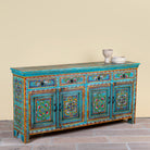 Side angle image of a Laksh hand painted reclaimed wood sideboard in boho style with distressed vintage finish and traditional Indian floral artwork.