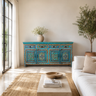 Lifestyle image of a Laksh hand painted reclaimed wood sideboard in boho style with distressed vintage finish and traditional Indian floral artwork.