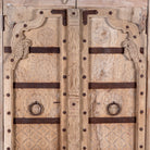 Close up image of a Lakshya bleached mango wood cabinet with original hand carved Indian door panels and iron fittings 167cm