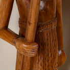 Close up image of a hand-carved Indian house guardian statue in exotic style, made from reclaimed wood; sustainable furniture, 40 × 20 × 120 cm.