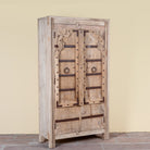 Side angle image of a Lakshya bleached mango wood cabinet with original hand carved Indian door panels and iron fittings 167cm