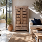 Lifestyle image of a Lakshya bleached mango wood cabinet with original hand carved Indian door panels and iron fittings 167cm