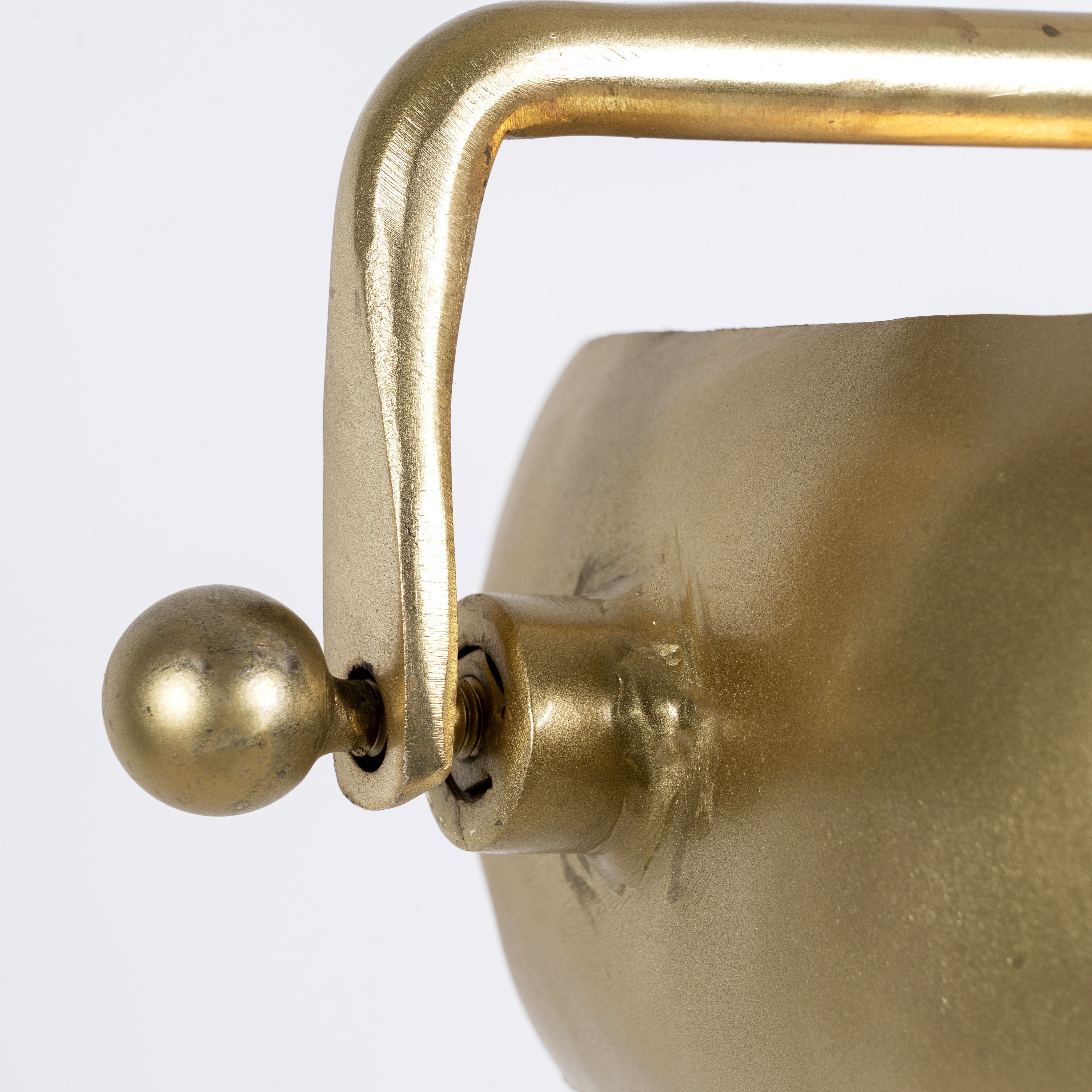 Close up image of a round artsy pendant lamp with clear hand-blown glass and brass-plated iron frame – retro lighting piece ideal for kitchens, dining rooms, or living areas.