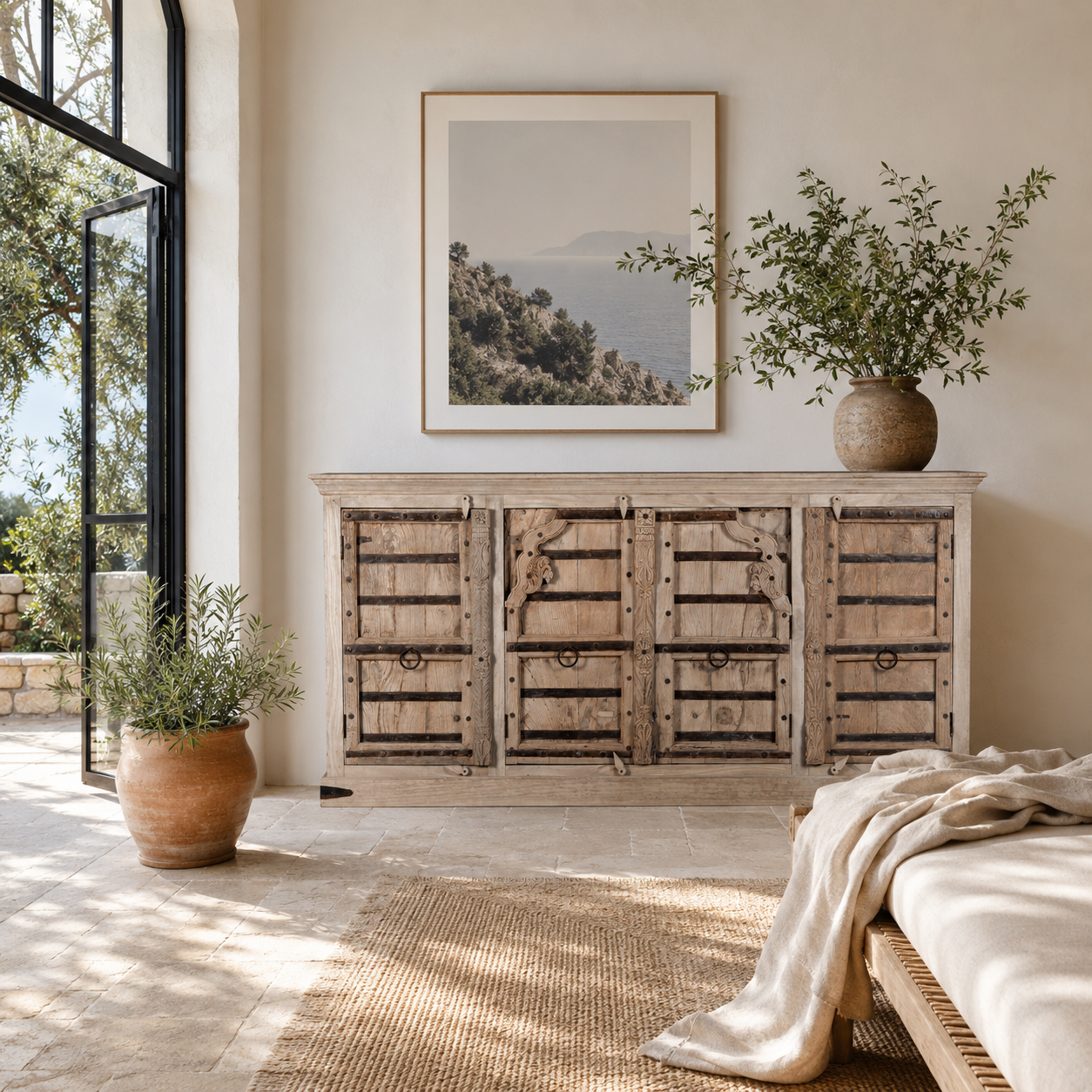 Lifestyle image of a unique old Door sideboard Laya, finely hand carved in bleached teak wood driftwood design.
