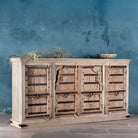 Sideview of a reclaimed teak furniture sideboard with antique Indian doors, old door cabinet with hand-carved details and iron accents, 220 × 45 × 110 cm.