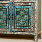 Close up image of the leg part of a hand painted furniture sideboard made from reclaimed teak wood with floral motifs, artisanal furniture in bohemian Mediterranean style, 180 × 40 × 90 cm.