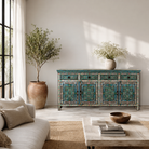 Lifestyle imagination of a hand painted furniture sideboard made from reclaimed teak wood with floral motifs, artisanal furniture in bohemian Mediterranean style, 180 × 40 × 90 cm.