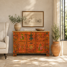 Lifestyle image of a recycled teak wood chest with hand-painted Indian motifs in orange – sustainable furniture with vibrant character and cultural craftsmanship.