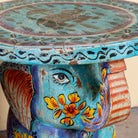 Close up image of a blue Leo hand painted solid wood elephant side table with traditional Indian artwork, available in yellow, red, and turquoise boho style designs.