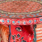 Close up image of a red Leo hand painted solid wood elephant side table with traditional Indian artwork, available in yellow, red, and turquoise boho style designs.