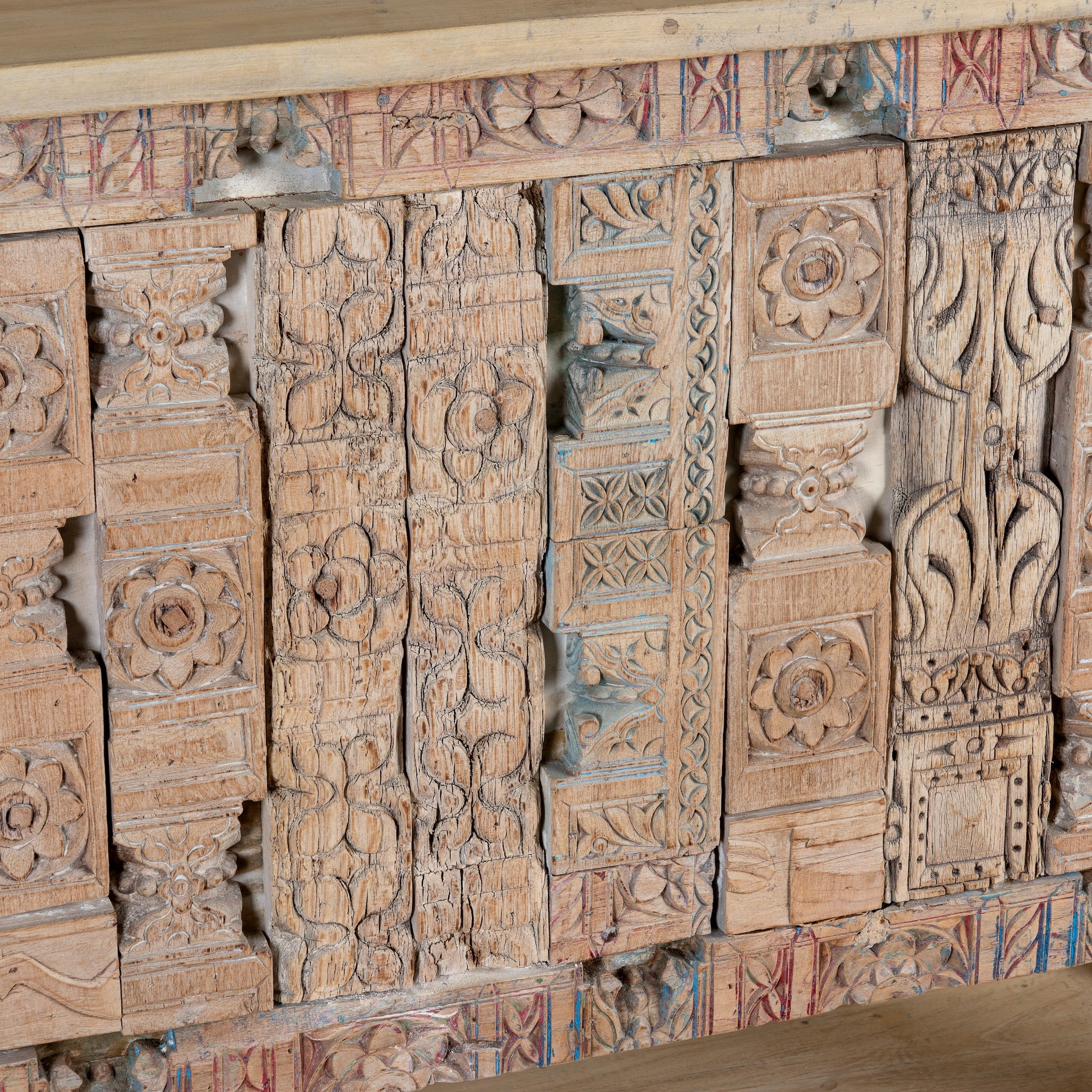 Close up image of a reclaimed teak console table with hand-carved antique elements and rustic finish, 140 × 38 × 93 cm.