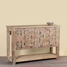 Side angle image of a reclaimed teak console table with hand-carved antique elements and rustic finish, 140 × 38 × 93 cm.