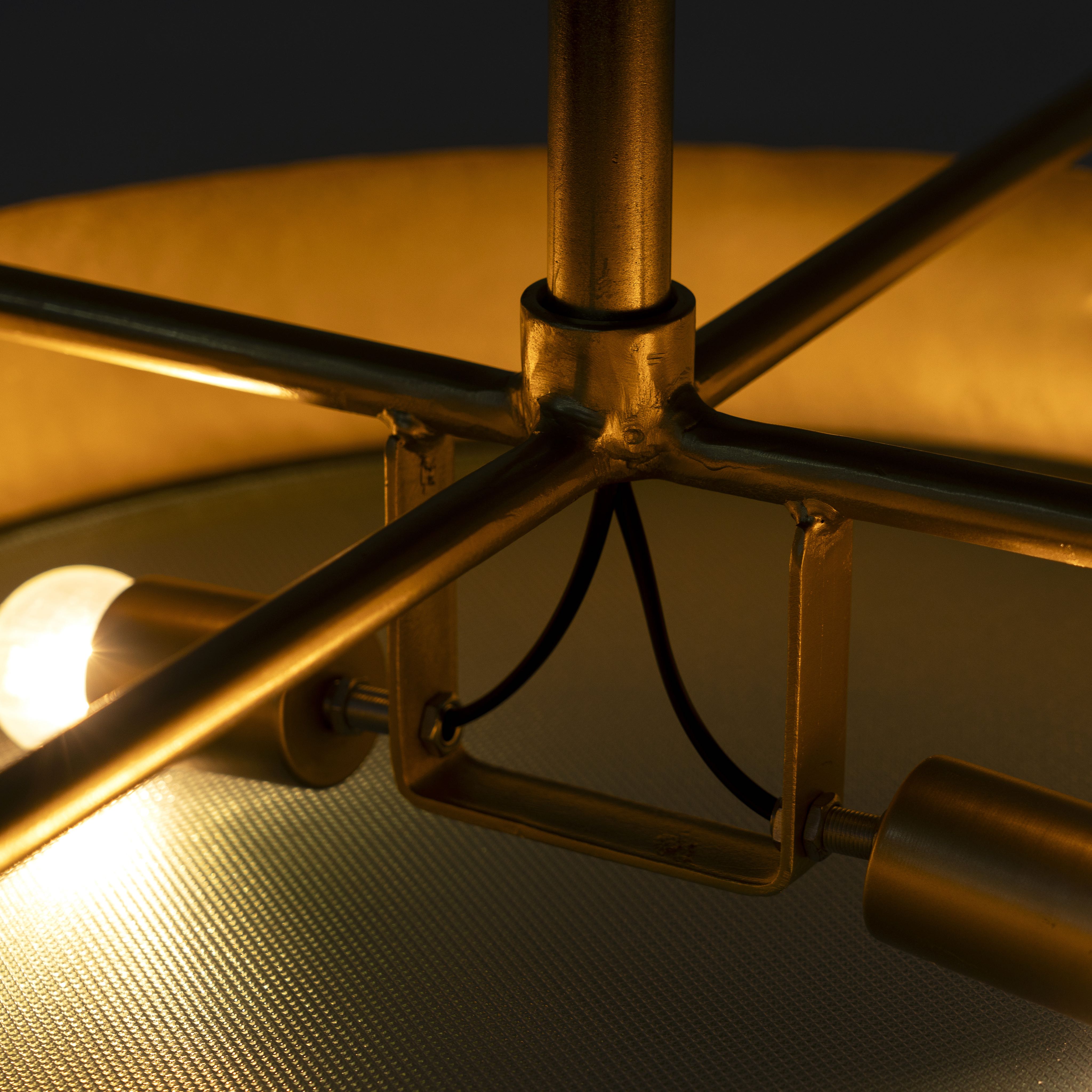 Close up image of a large round pendant lamp with clear hand-blown glass and brass-plated iron frame – retro lighting and artsy lamp ideal for kitchens, living rooms, or dining areas.