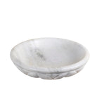 White background image of a hand-carved white marble bowl Padma with lotus flower design. A vintage home accessory perfect for styling in vintage home decor with natural stone craftsmanship and soft grey veining.