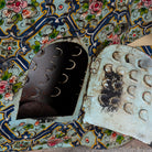 Close up image of a Maah hand painted freestanding metal fish sculpture featuring Delft-inspired blue tile patterns with pink floral motifs, handcrafted decorative home accessory, 107x15x80cm.