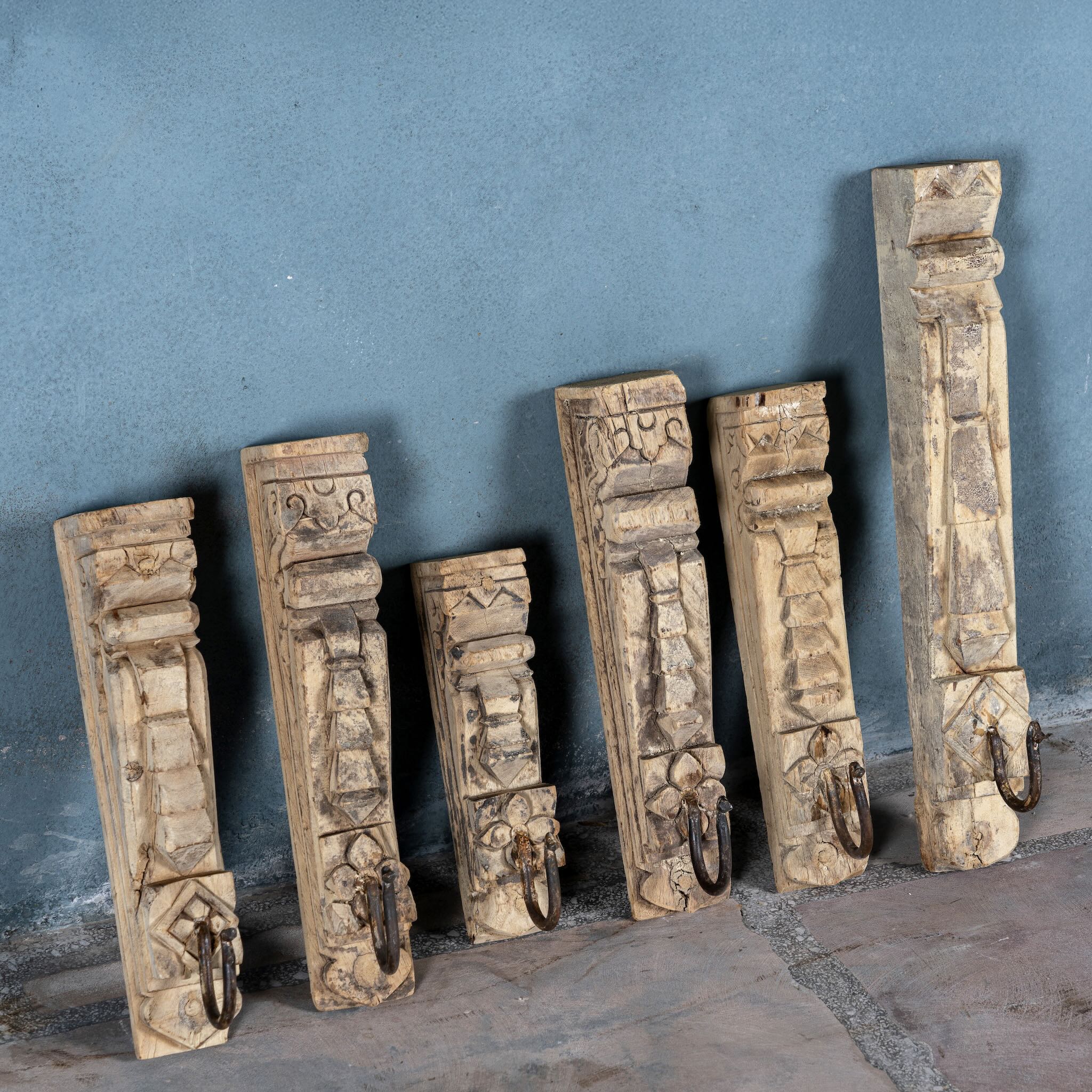 Hand-carved teak wood wall hooks Mahin made from antique house parts with mixed carvings and aged patina. A vintage home accessory and unique Indian decoration perfect for vintage home decor in entryways or bathrooms.