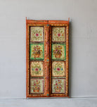 Hand-painted antique teak wood Indian door with floral motifs, rustic orange frame, reclaimed wood vintage wall panels for bohemian and vintage home decor.