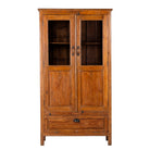 White background image of a tall reclaimed teak wood display cabinet with two glass doors and a bottom drawer – wooden display cabinet crafted as sustainable furniture with natural elegance.