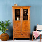 Tall reclaimed teak wood display cabinet with two glass doors and a bottom drawer – wooden display cabinet crafted as sustainable furniture with natural elegance.
