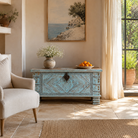 Lifestyle image of a blue hand-carved mango wood chest with floral and geometric carvings – wood chest box perfect for boho style storage or decorative accent.