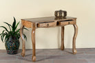 Side angle image with open drawers of a desk made of natural mango wood with 2 drawers and carved legs.