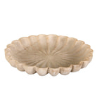 Decorative stone bowl with scalloped edge on a white background