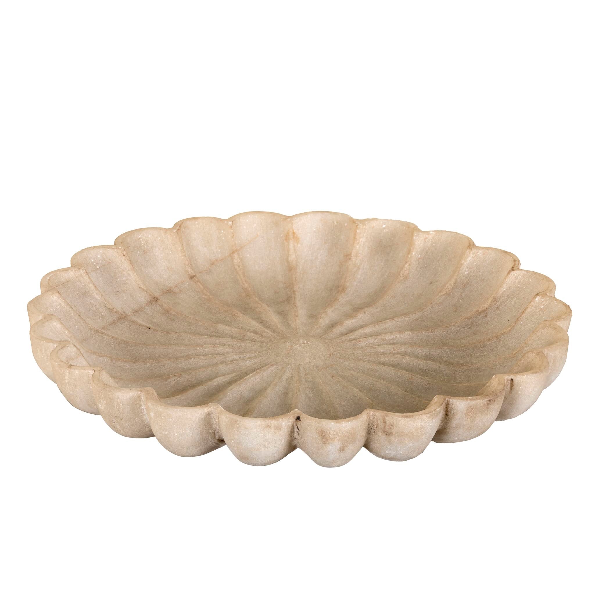 Decorative stone bowl with scalloped edge on a white background