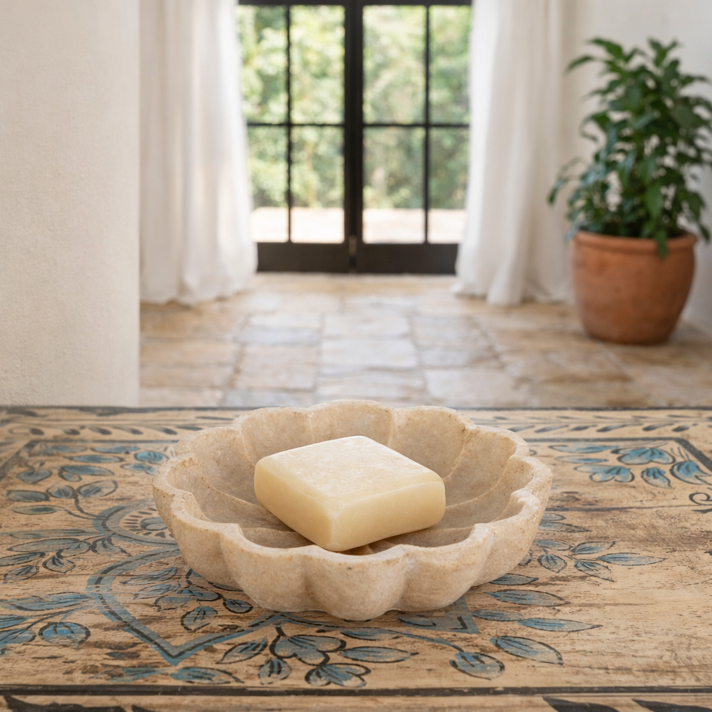 Lifestyle image of a hand-carved marble flower plate Tanush with delicate petal detailing. A vintage home accessory and unique Indian decoration, perfect as a soap dish, jewellery tray, or sweet plate for vintage home decor.