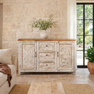 Lifestyle image of a handcrafted carved sideboard made from solid mango wood with floral motifs, antique layered finish, and natural wood top; artisan vintage furniture, 150 × 40 × 90 cm.