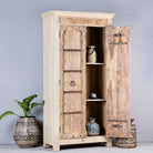 Open door image of a rustic solid wood wardrobe featuring vintage reclaimed door panels with iron accents and ring pull handles.